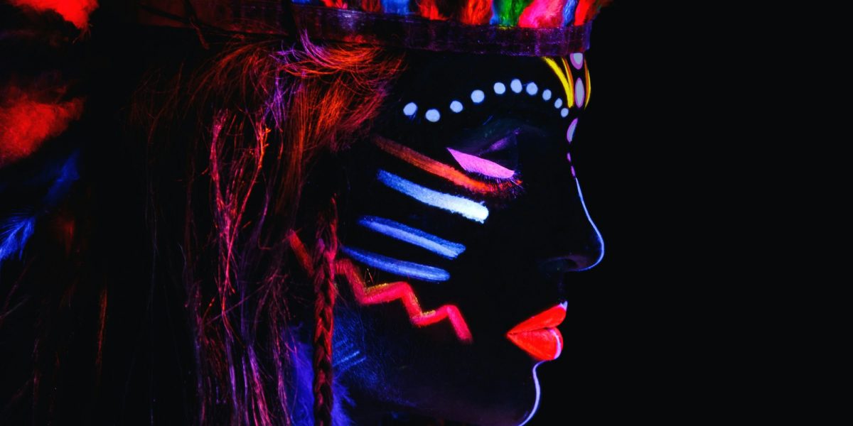 Model in image of Native american with neon makeup